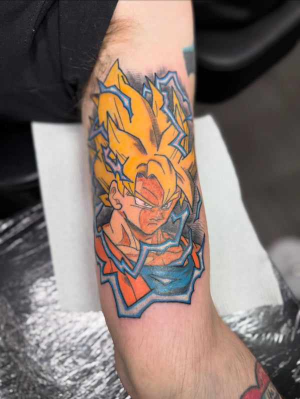 Colour anime Goku tattoo on forearm