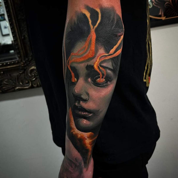 Black and grey realism tattoo of a woman with flames