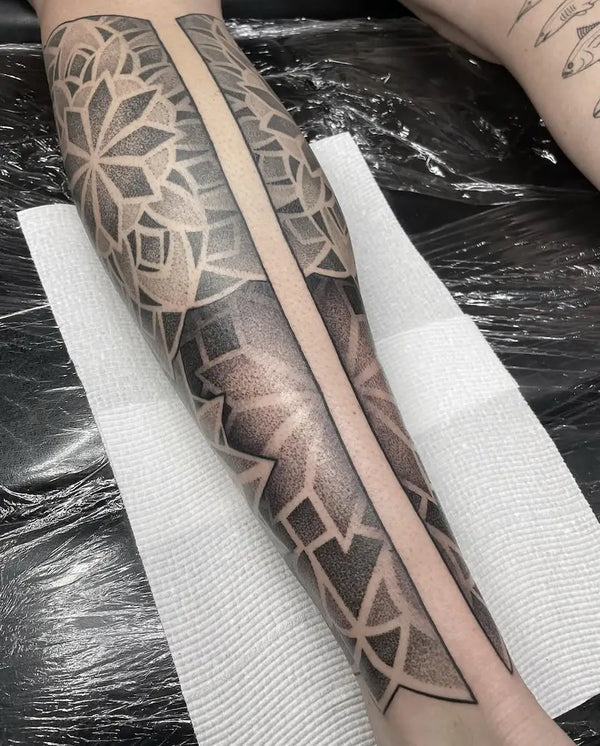 Geometric mandala dotwork tattoo on calf